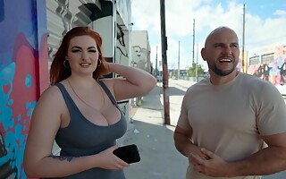 Bald stud fools around with curvaceous redhead in the streets